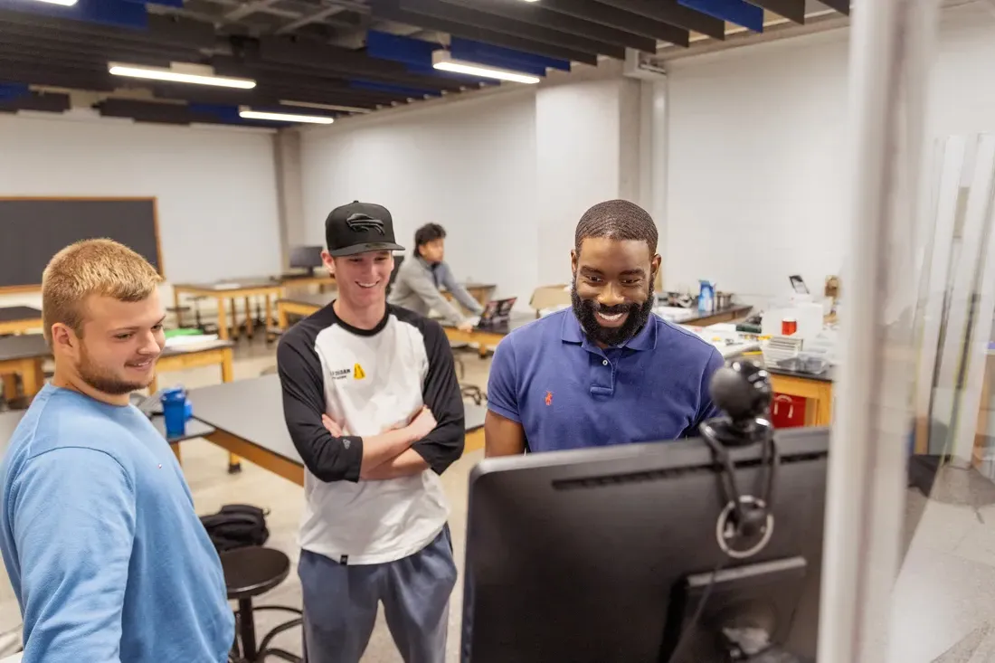 People looking at a computer.