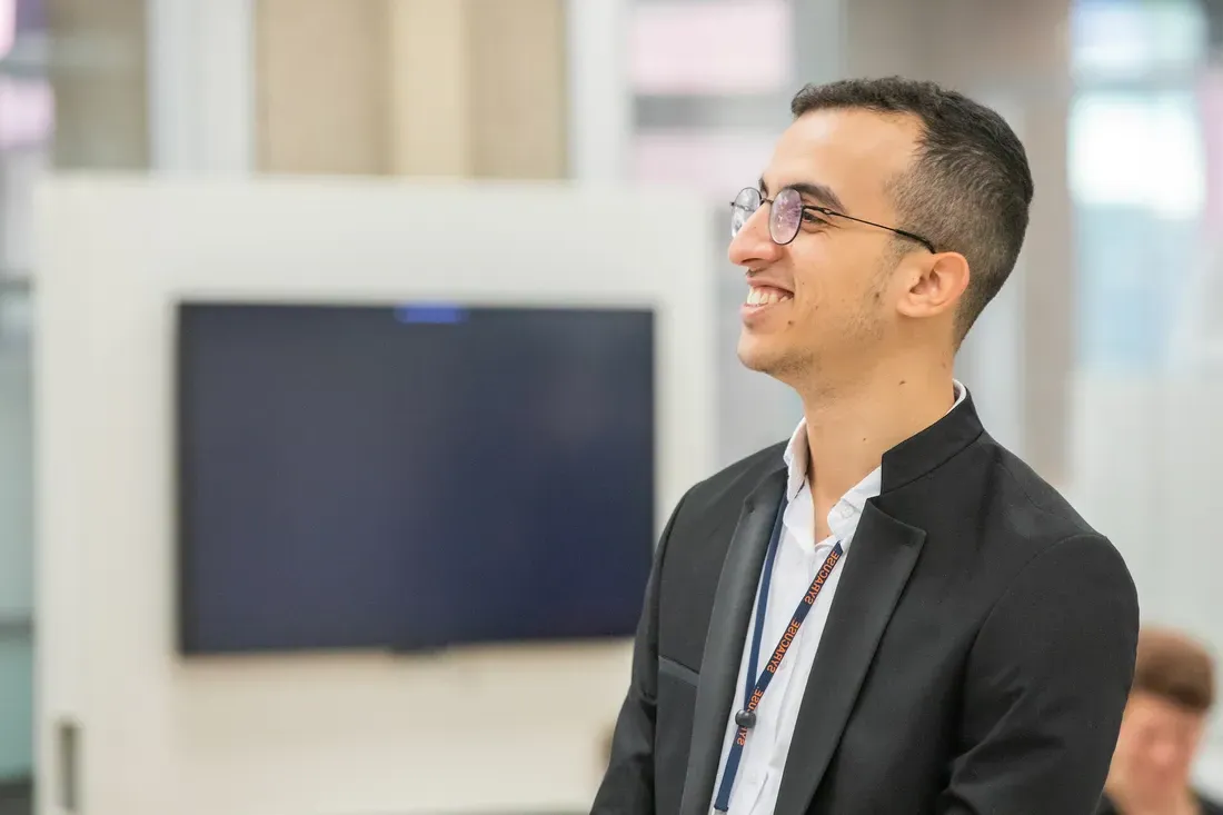 Student standing and smiling.